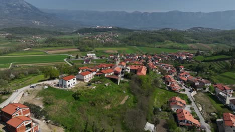 vipava rural village in slovenia in lush green valley aerial pullback