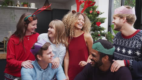 portrait  of friends enjoying christmas party at home together