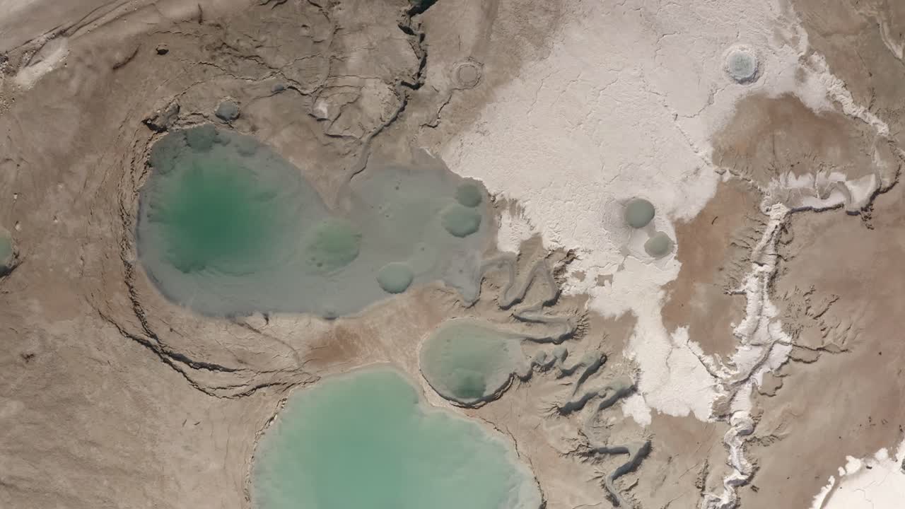 Aerial View of a Dried Salt Lake Bed with Pools of Turquoise Water