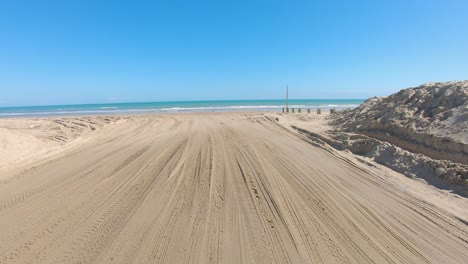 pov driving on to beach thru access 5 at south padre island on the gulf side of barrier island