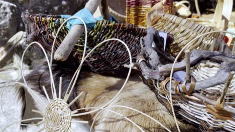 Closeup-of-woven-reed-goods-baskets-and-decorations-on-animal-fur,-lonoa-spain