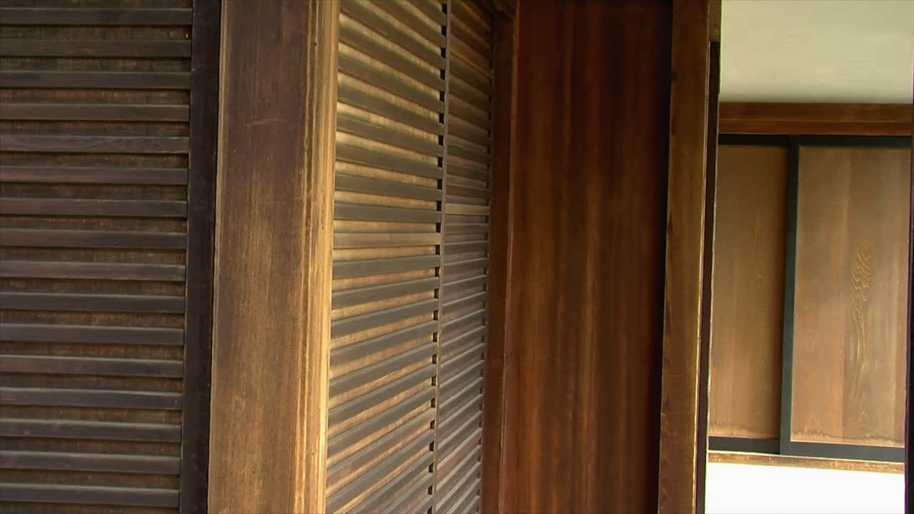 Pan across exterior of Japanese house with hinoki wood exterior walls, or "amado