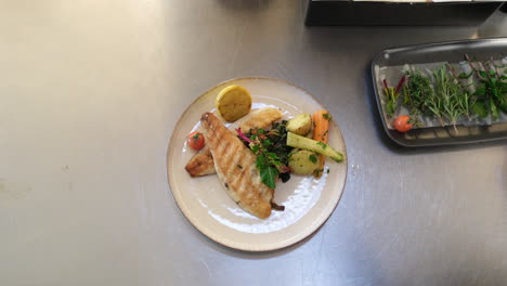 crisp grilled fillet with a side of herb-infused potatoes and greens