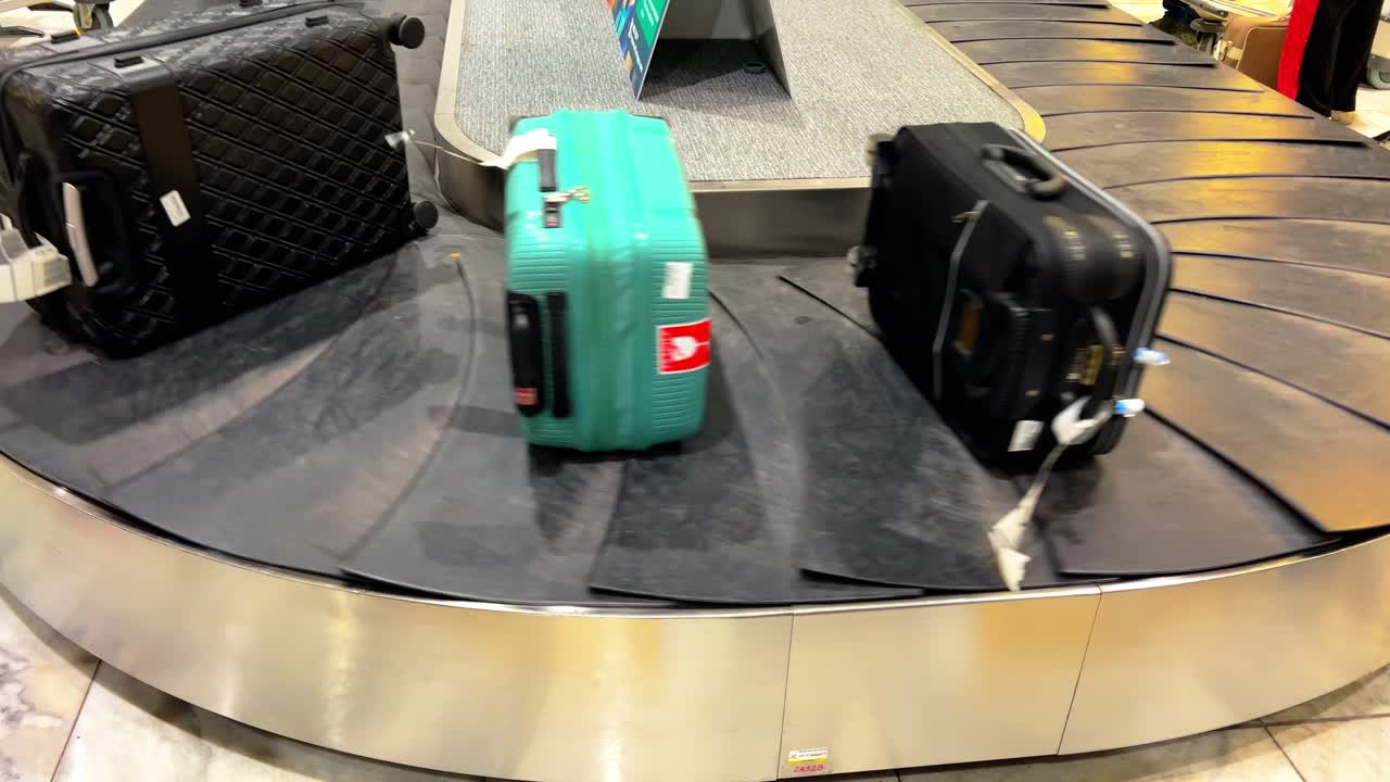 Vibrant suitcase with world landmarks design on an airport baggage carousel, perfect for travel, tourism, and holiday-themed projects