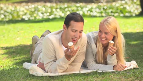 young couple eating icecream and laughing