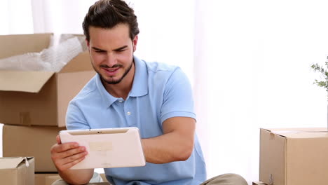 Man-using-a-tablet-in-his-living-room