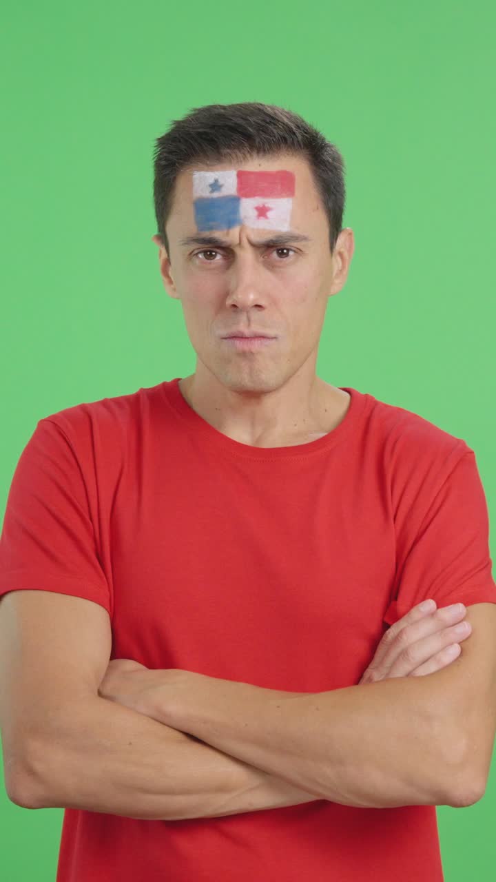 Dignified and serious man with panamanian flag painted on face