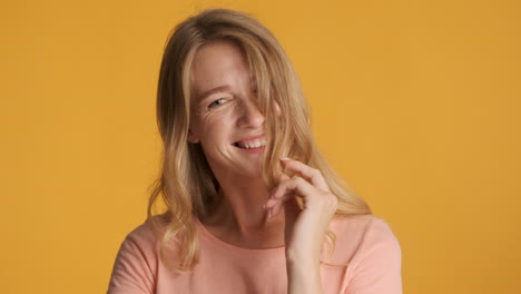 caucasian woman showing flirting gestures on camera.