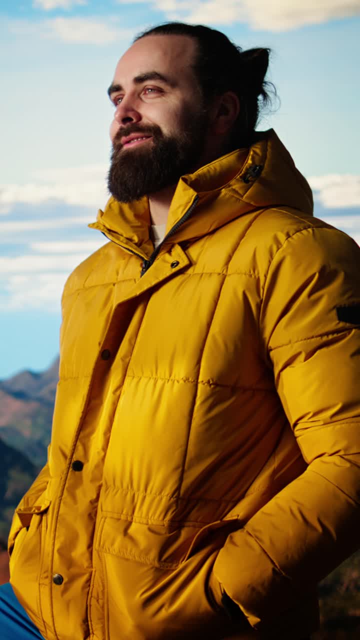 Bearded Man in Yellow Jacket Enjoying Serene Mountain View