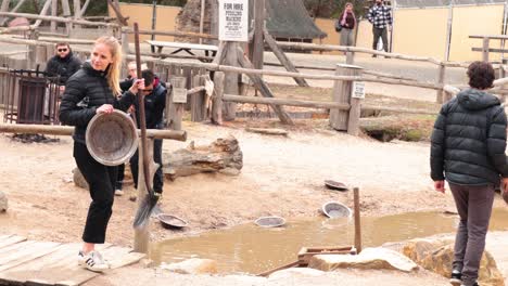 people panning for gold in historical setting