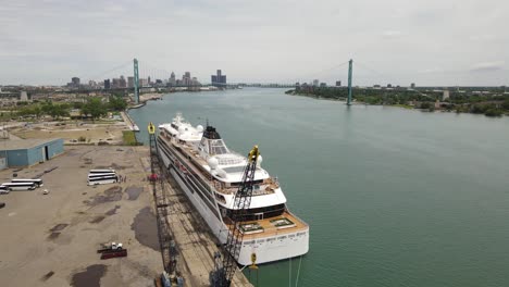 norwegian cruise ship moored in detroit port, aerial orbit view