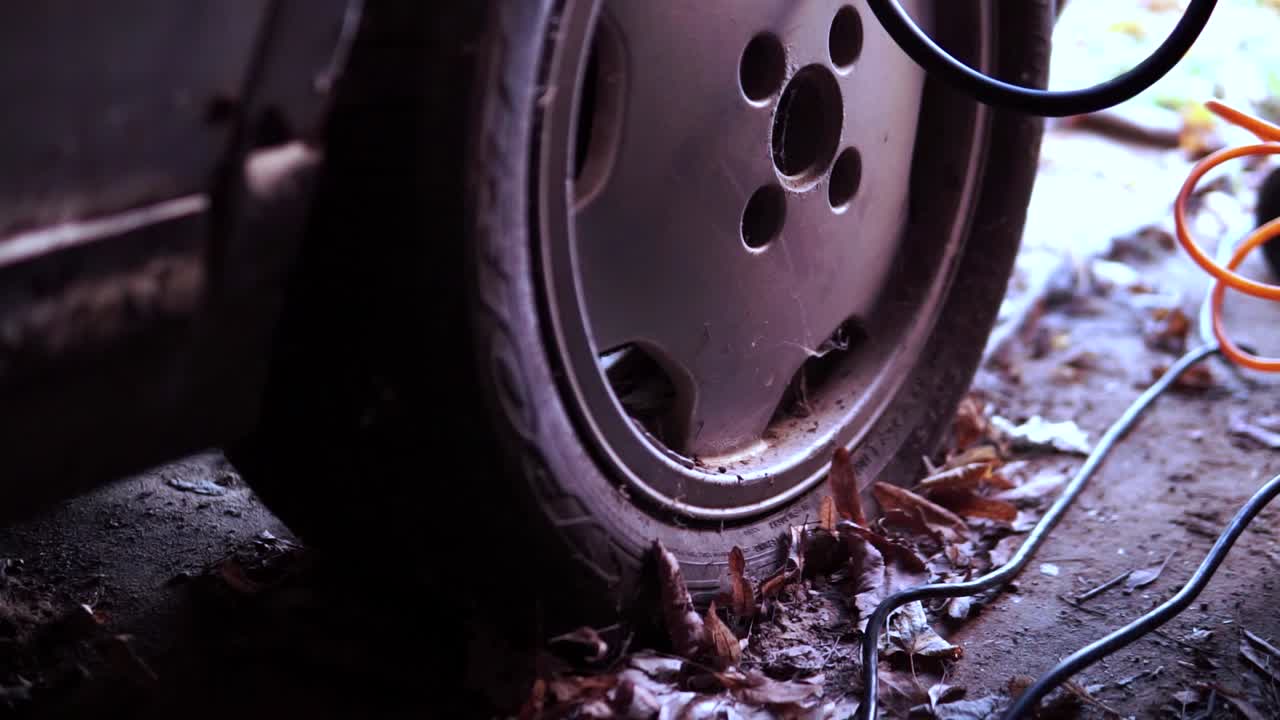 A man inflates a car tire