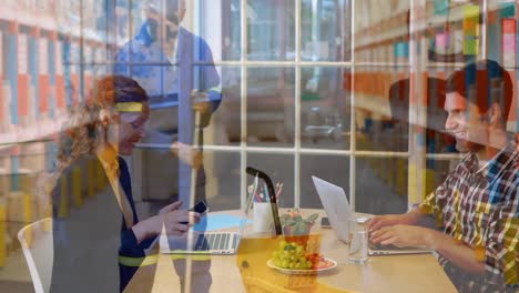 animation of coworkers discussing in office over caucasian man mopping floor of warehouse