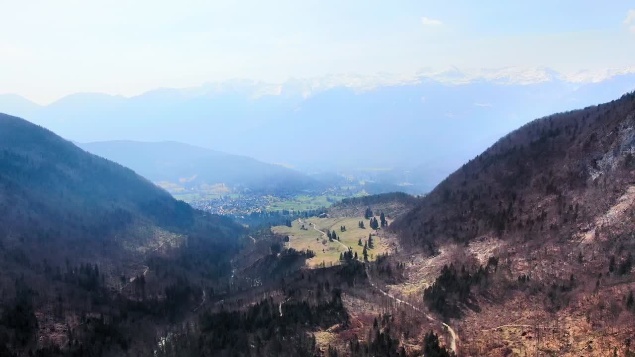 Wide angle aerial dolly in Drone shot of mountains, valleys and hills in the Julian Alps, Triglav national Park during the day