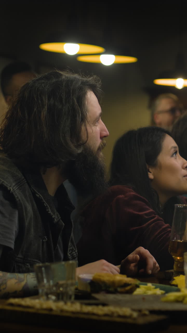 Friends watching at a bar