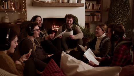 group of friends with headphones gathered by a fireplace