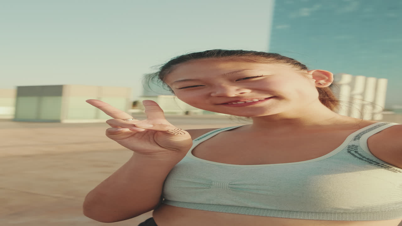 Asian woman in sports bra taking selfie