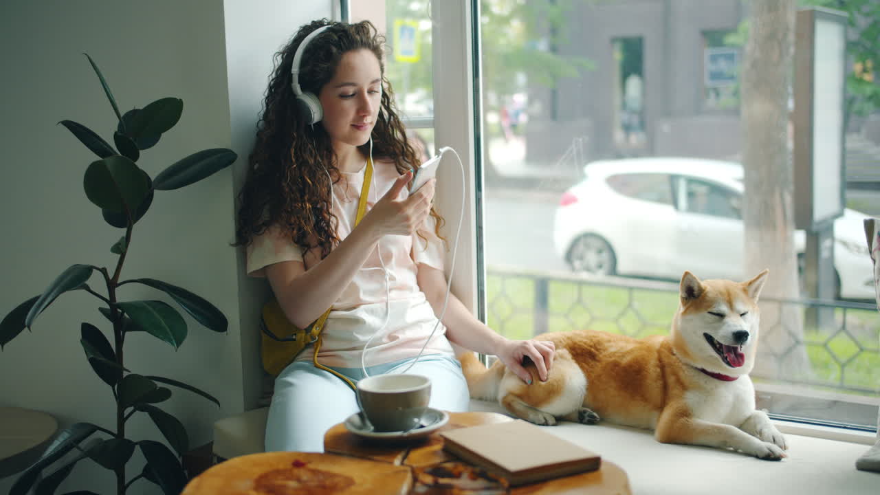 Woman relaxing in a cafe with her dog