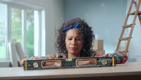woman using a level for home improvement