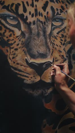 artist painting a leopard portrait