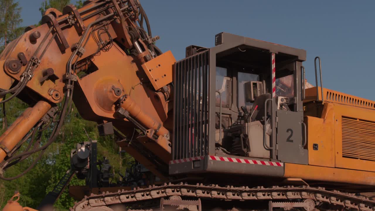 disabled excavator on golden hour blue sky