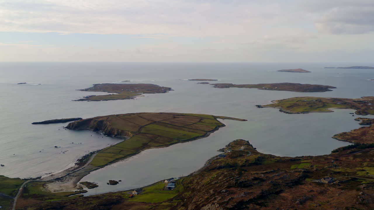 Aerial trucking shot of rural islands, including Turbot and Inishturk, in Clifden Bay. Sky Road, Connemara