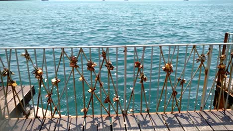 A-metal-railings-on-the-coast,-urban-coast-and-railings-with-locks,-Thessaloniki-Greece