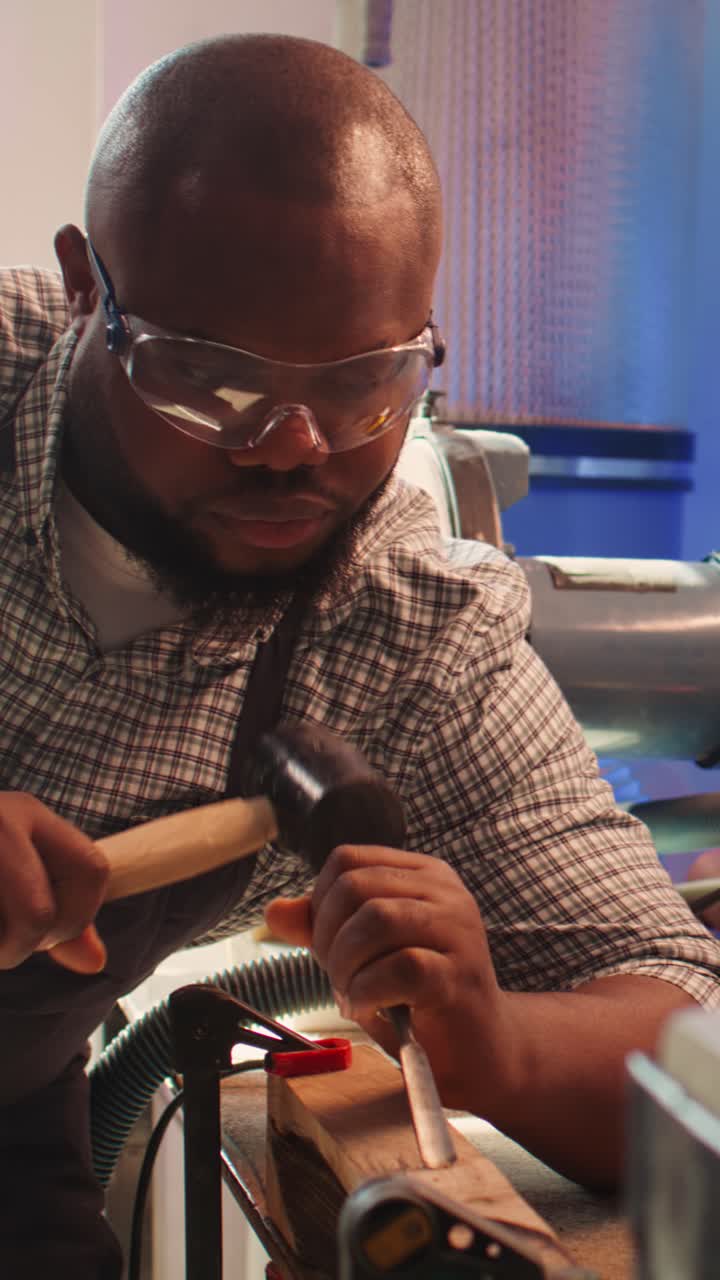 African American Carpenter Carving Wood with Chisel and Mallet