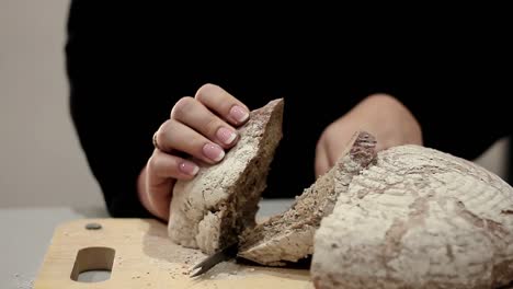 cutting bread with a bread knife in the kitchen with people stock videos stock footage