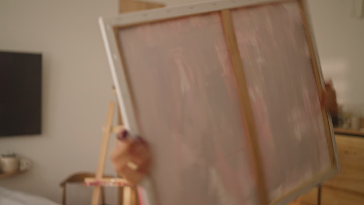 Woman painting in her home studio