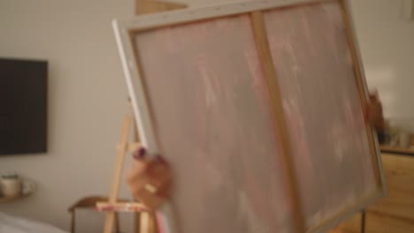 woman painting in her home studio