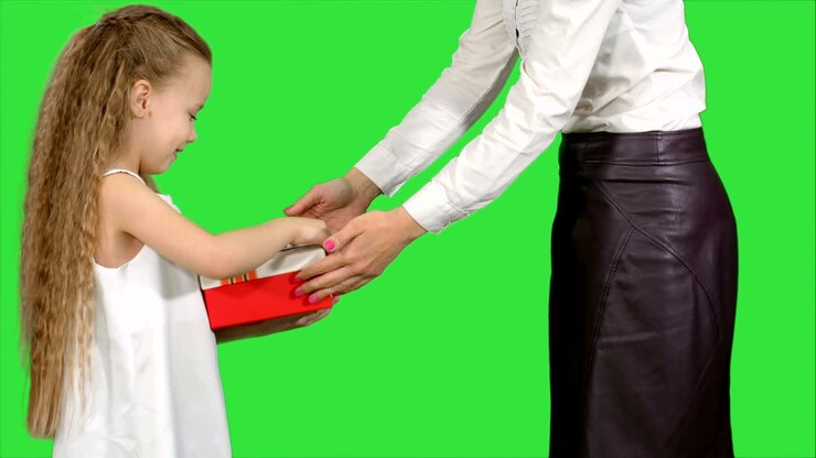 Young charming mother and her cute daughter opened Christmas gifts on a Green Screen, Chroma Key