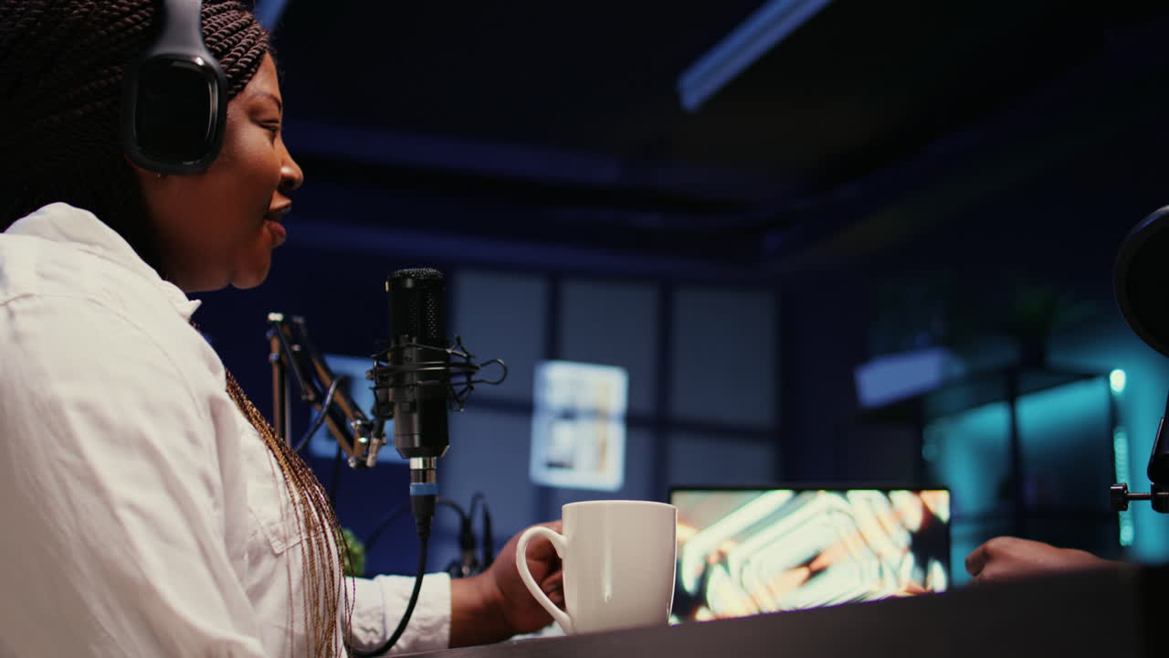 Guest amused by talking show host telling jokes to her and audience watching at home