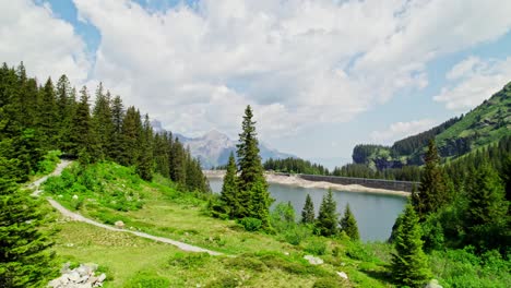 mountain reservoir lake in swiss alps, switzerland - aerial drone flight with copy space