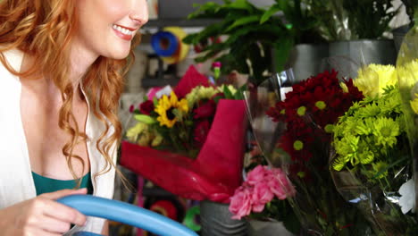 female florist watering flowers