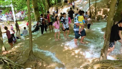 people walking through a waterfall