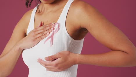 video of biracial woman touching her pink breast cancer ribbon