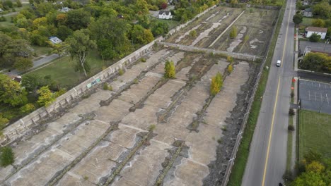 Concrete-water-reservoir-left-abandoned-in-Detroit-city,-aerial-view