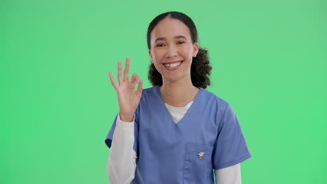 a smiling nurse gives the okay sign