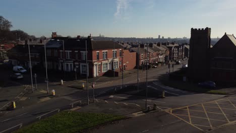 aerial view reveals rows of historic terraced houses and church street scene at sunrise