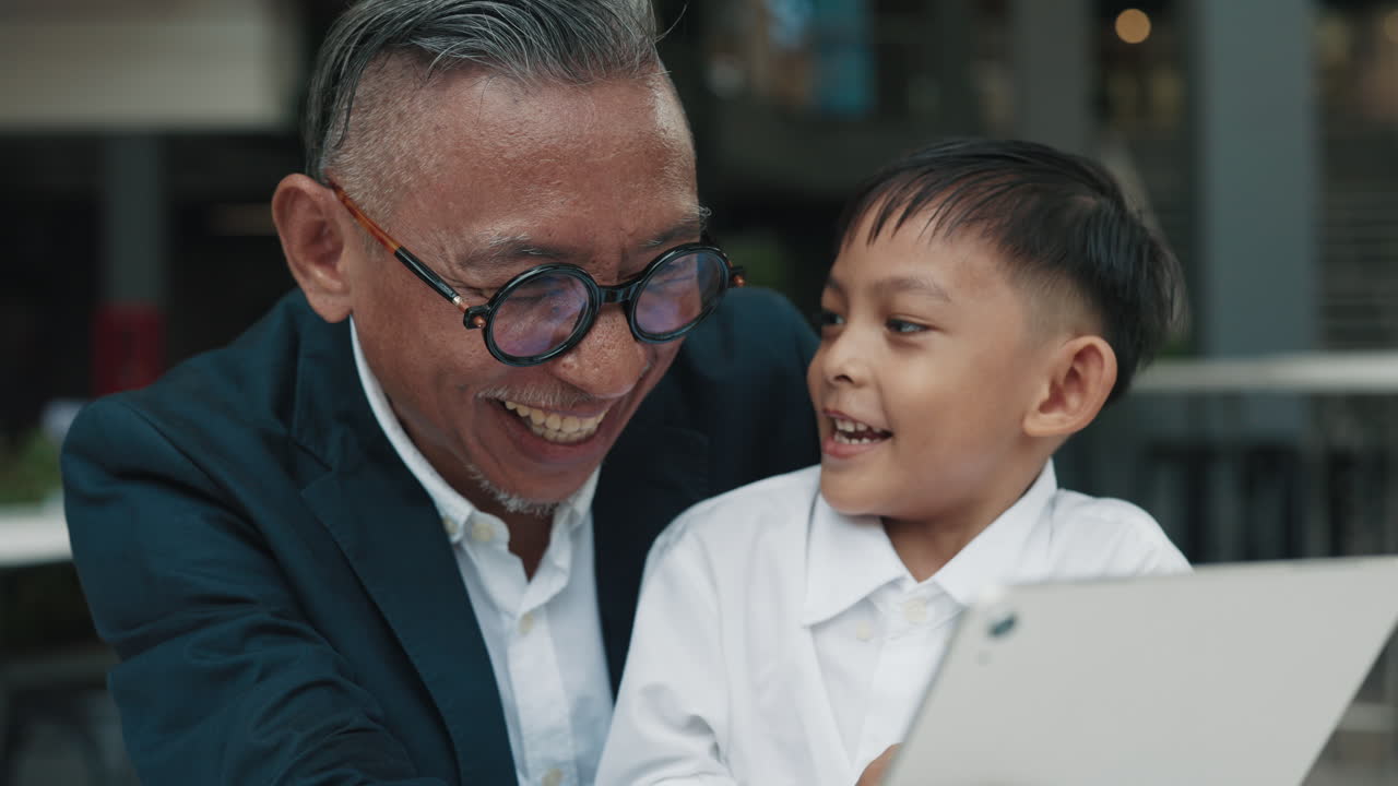 Grandfather and Grandson Bonding with a Tablet