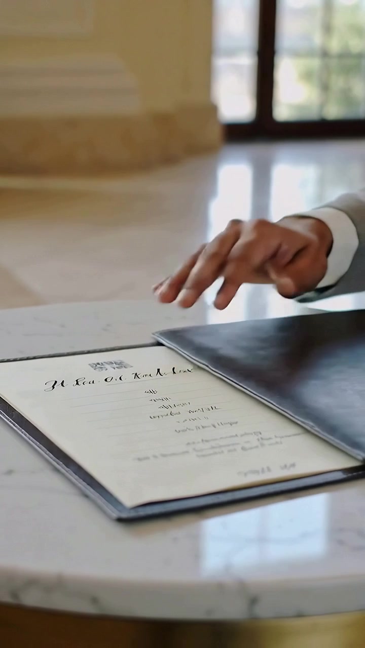 Vertical video: Lifting suited man pulling crest menu closing folio aligning at lobby, copy space