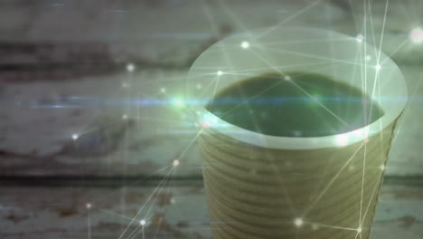 corrugated cup holding dark brew on wooden table, showing glowing network overlay, casting streaks