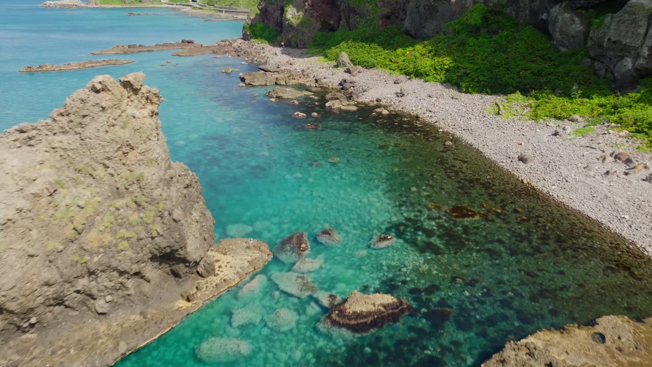 Aerial fly close to details in Japanese sea cape beach of Shakotan Hokkaido, summer travel hidden spot