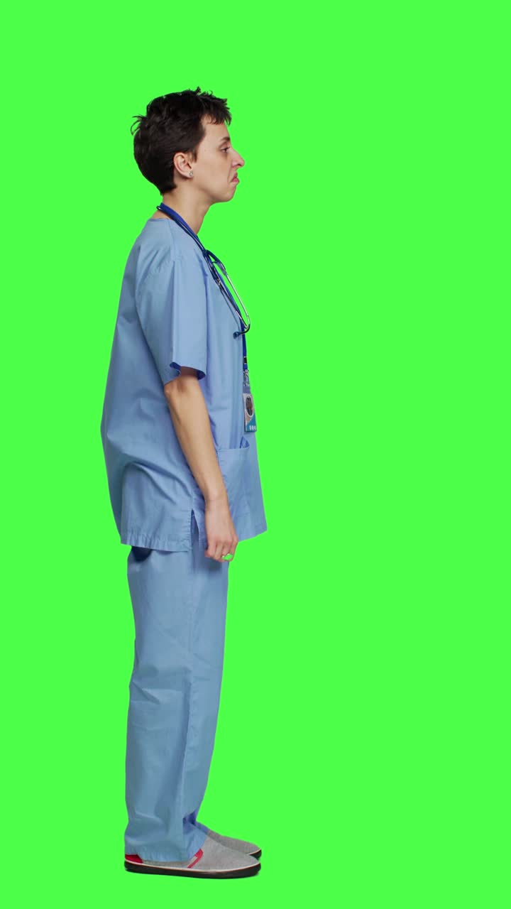 Profile Displeased medical assistant shows thumbs down in studio