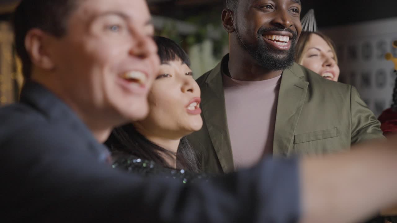 foto de seguimiento de un grupo de amigos levantando sus copas y diciendo feliz año nuevo