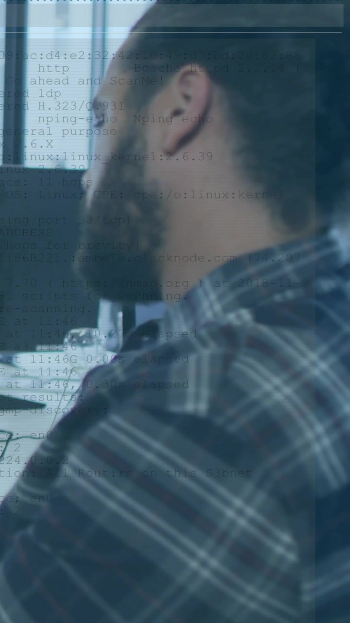 Vertical video: Dev leaning at desk, studying code for QA while monitor activating overlay on left
