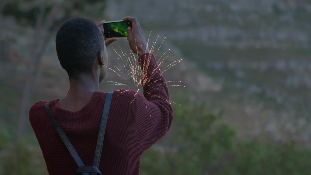 Vertical video: Holding woman in maroon top wearing pack framing slope, green phone sparking sleeve