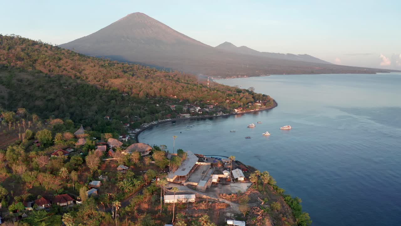 Aerial view of Bali tourism town Amed with Mount Agung volcano in background, Indonesia