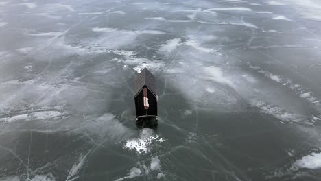 winter wonderland: an aerial shot of ice fishing on frozen lac la hache lake in british columbia, canada